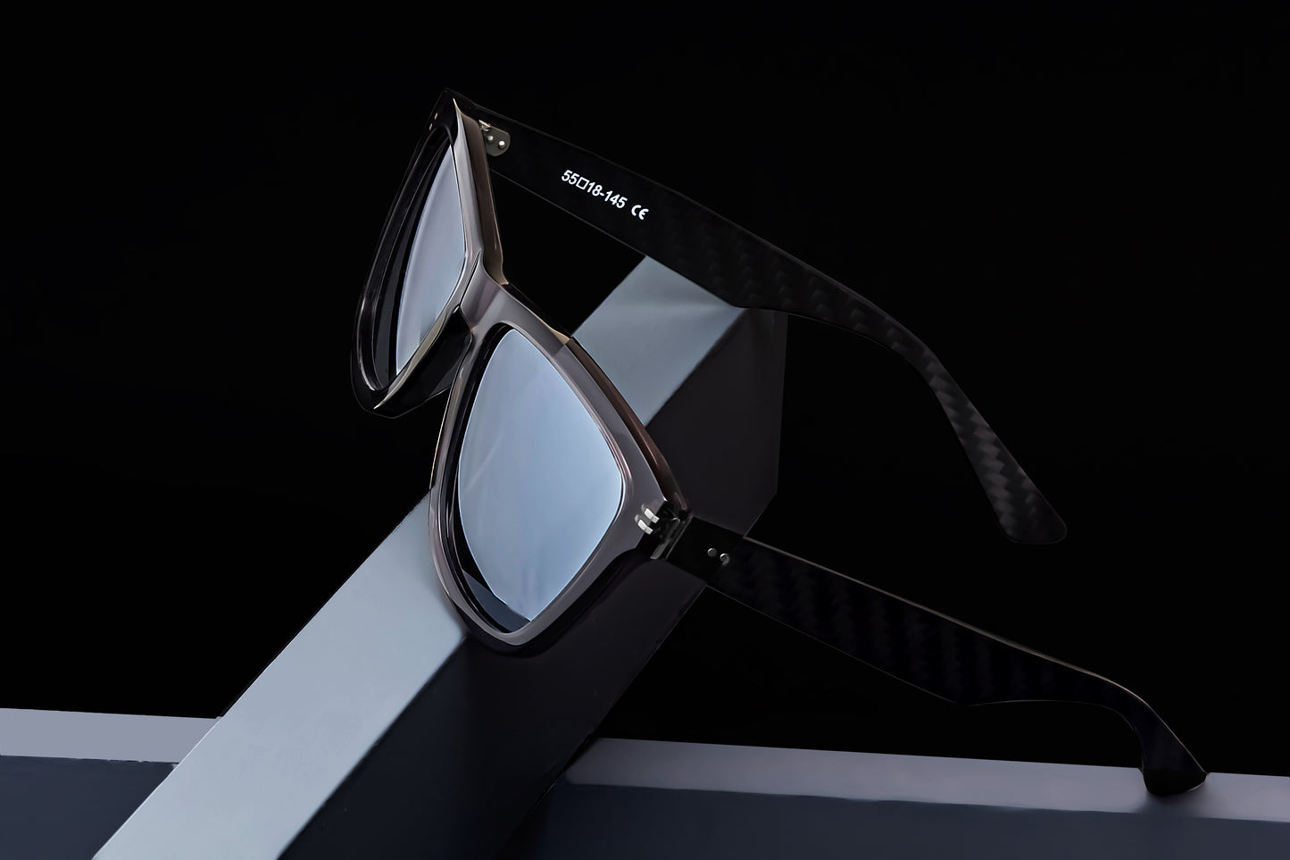 Parabolica Silverstone carbon fiber sunglasses, translucent black with mirrored polarized lenses, studio.