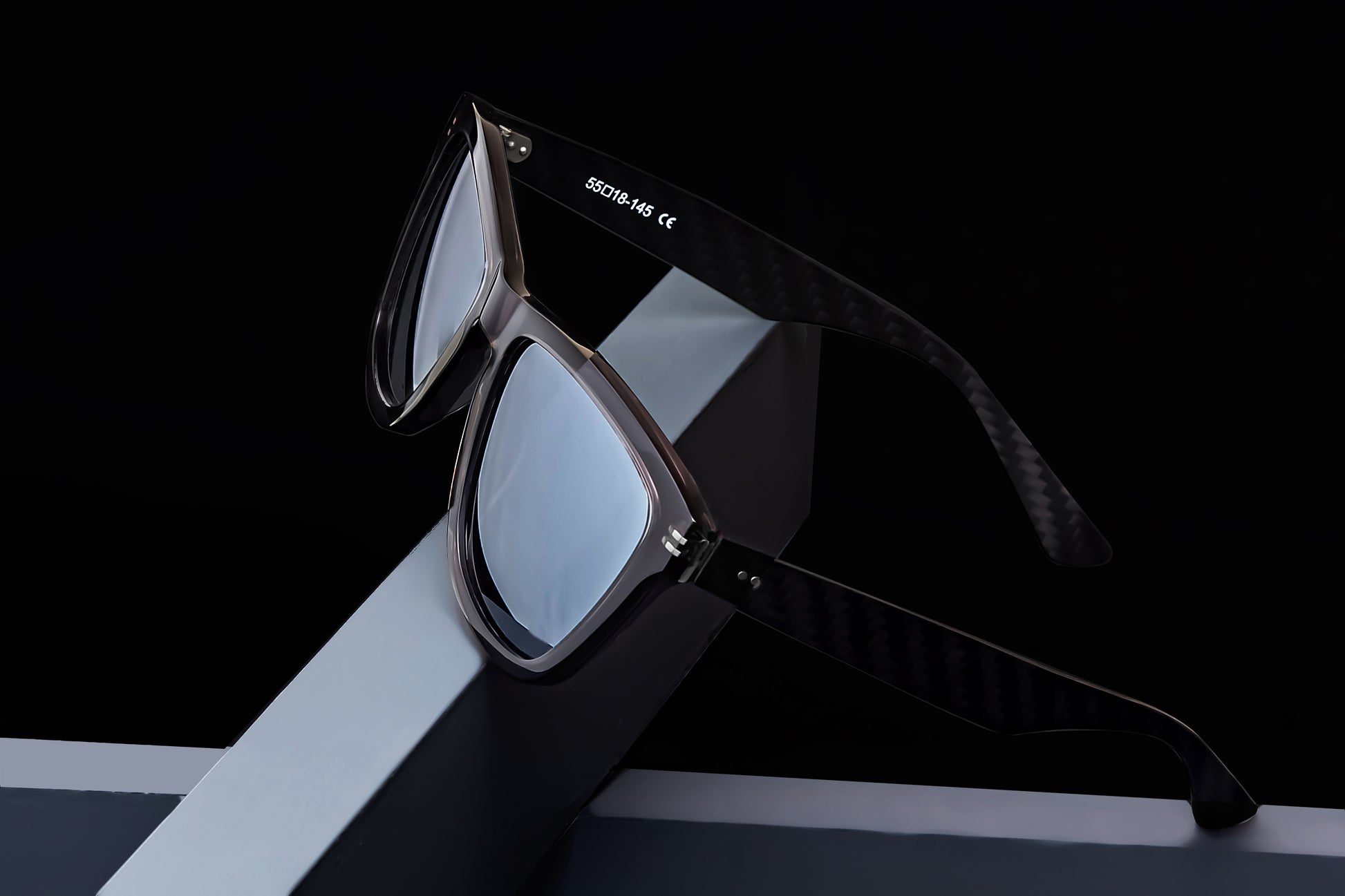 Parabolica Silverstone carbon fiber sunglasses, translucent black with mirrored polarized lenses, studio.